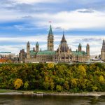 Stunning autumn view of Parliament Hill across the Ottawa River in Ottawa, Canada